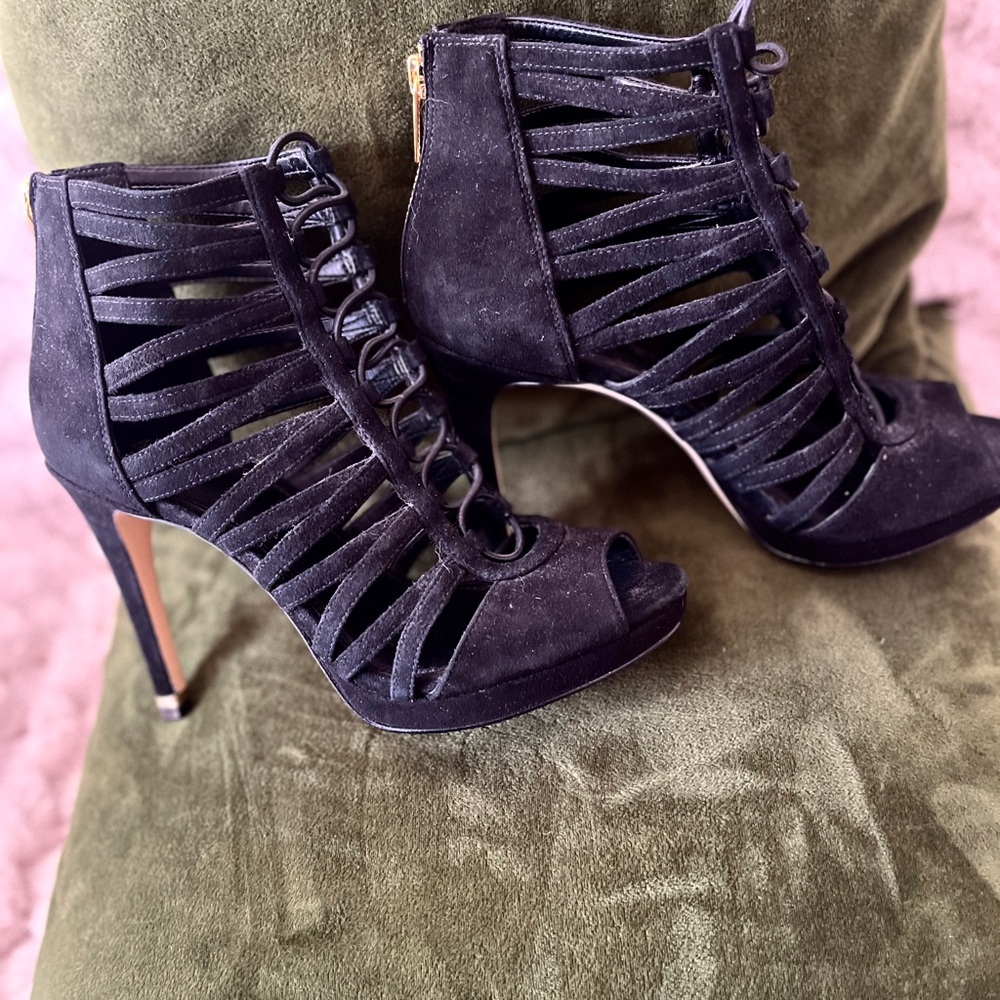 Black high-heeled shoes with open-toe design and stiletto heel